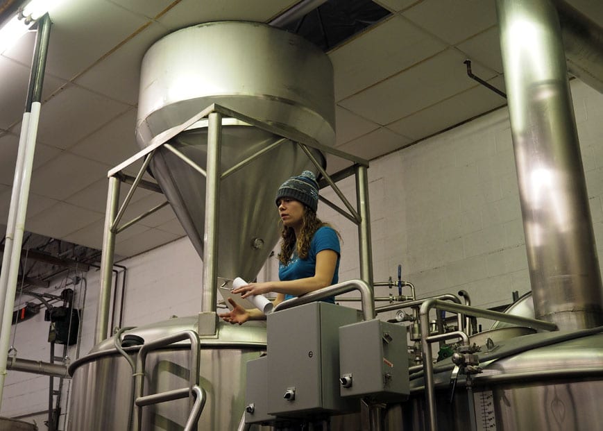 Lauren between the mash tun and boil kettle.